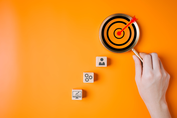 Magnifying glass with business target goal icons